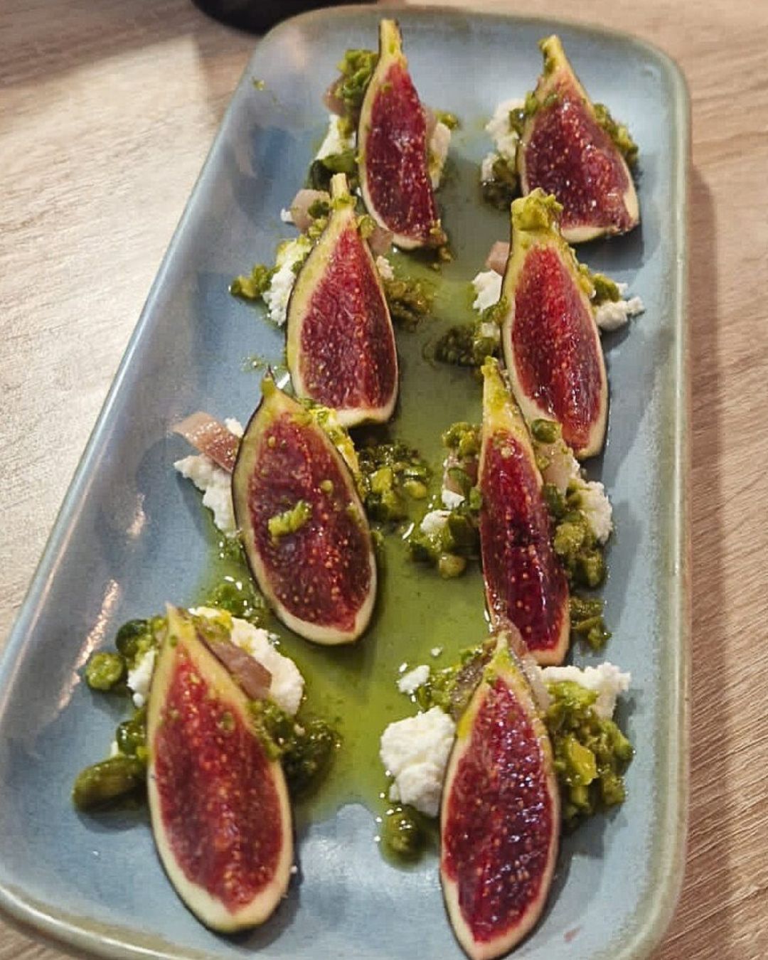 Plating fig salad, cottage cheese, smoked sardine and pistachio oil